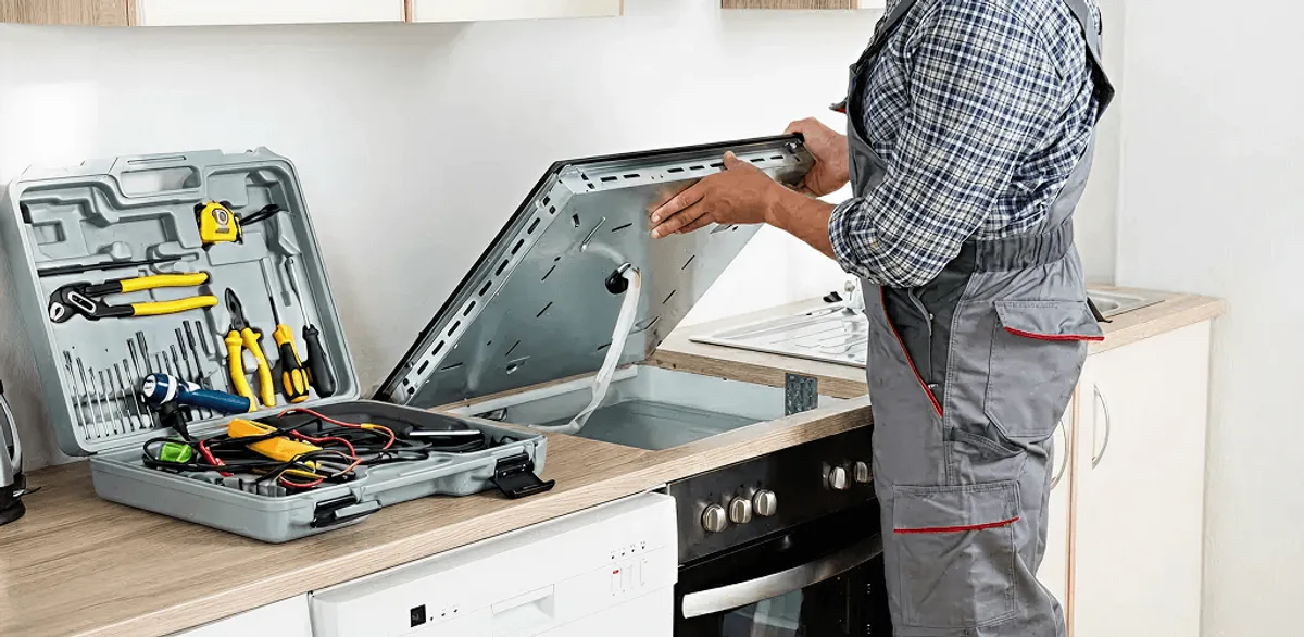 Handyman repairing a cooktop and checking wiring connections in Glendale, AZ