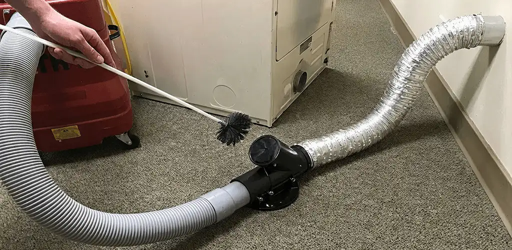 Dryer vent cleaning service removing lint from a dryer duct connection in Glendale, AZ