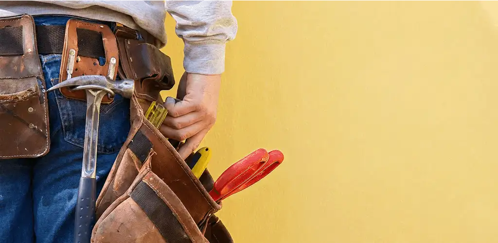 Handyman with tool belt ready for home repairs and maintenance in Glendale, AZ