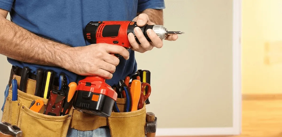 Handyman holding a power drill for home repairs and installations in Glendale, AZ
