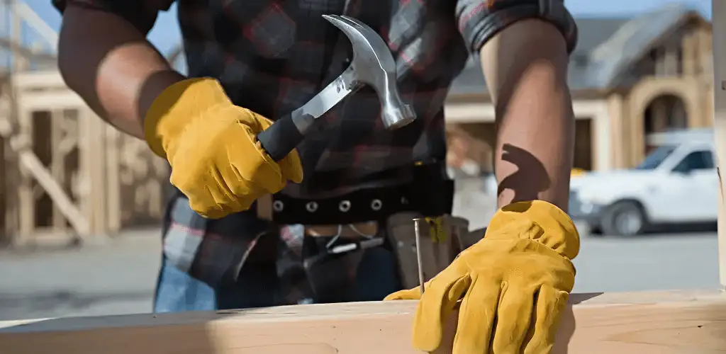 Handyman fixing wood trim with a hammer for home repairs in Glendale, AZ