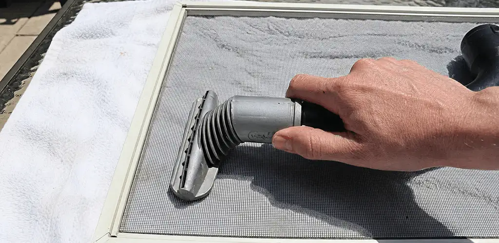 Window screen repair cleaning and fixing a damaged screen mesh in Glendale, AZ